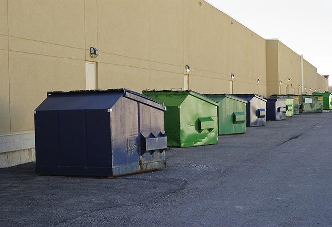 metallic dumpster units staged for construction garbage in Dedham